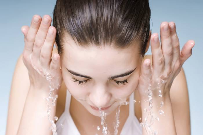 woman washing her face