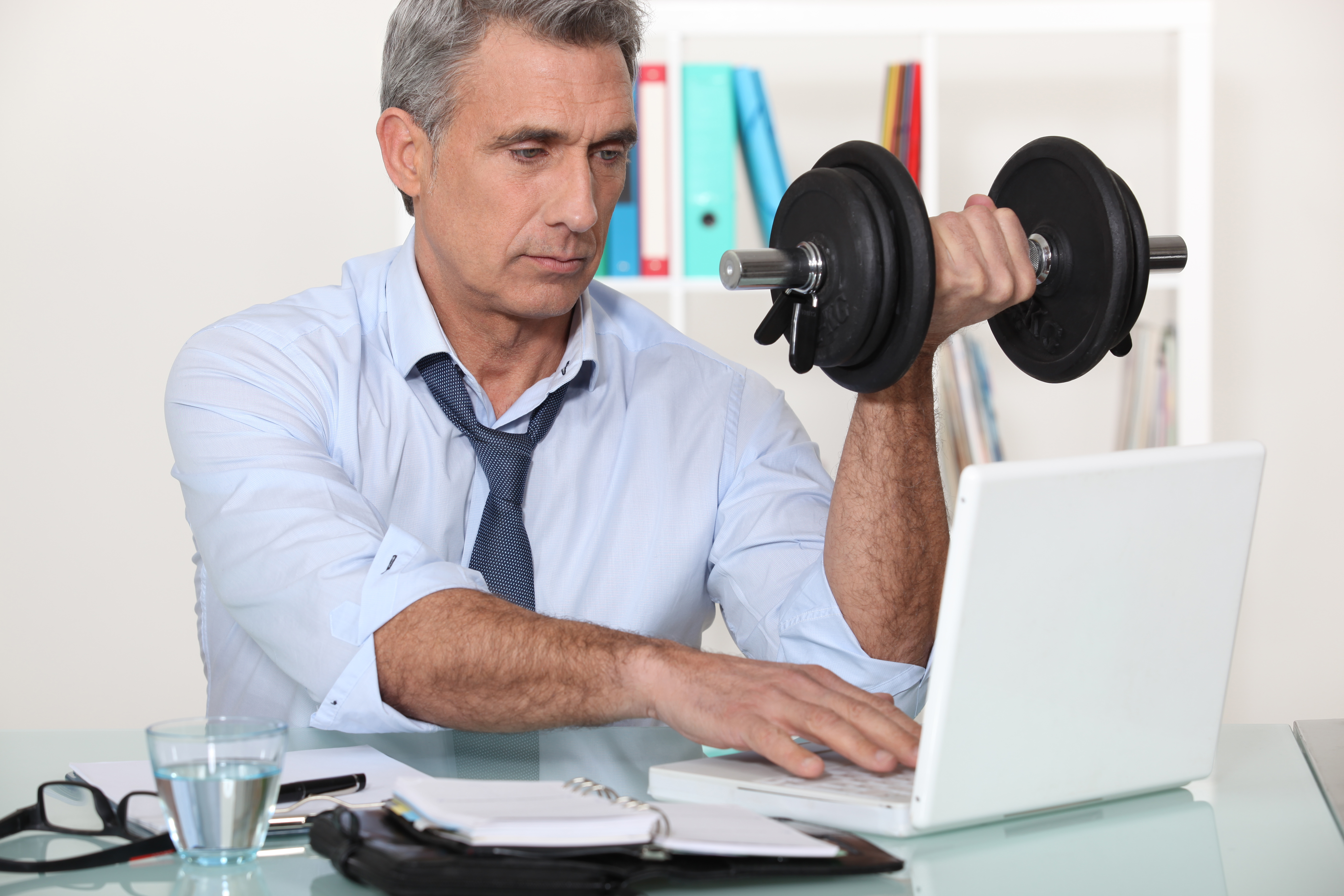 A man exercising while working